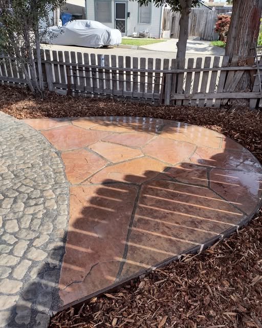 Paver patio bordering stamped concrete