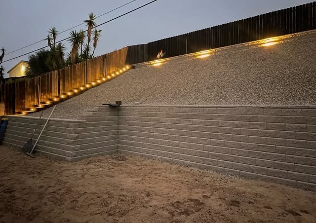 Segmental block retaining wall with integrated lighting
