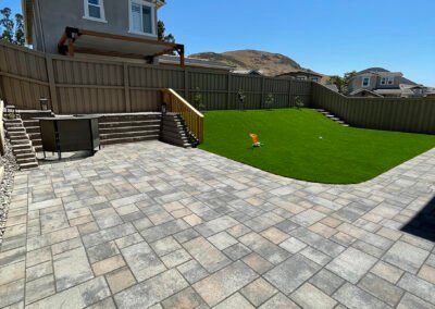 Backyard combining pavers, turf, sod and concrete