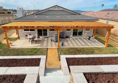 Pergola over paver patio with stairs and concrete work